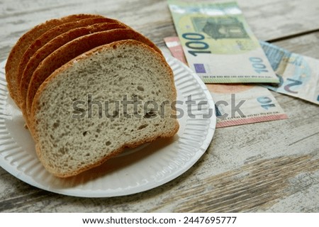 Bread on a plate on the table next to euro bills of different denominations, sale of bread in Europe