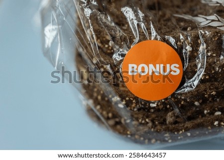 Bread in a plastic package with an orange discount bonus sticker, from the supermarket sale to reduce food waste and to attract customers to buy more items