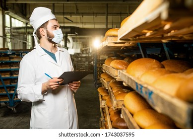 Bread. Bread production line. A man in uniform. Sanitary check. bakery - Shutterstock ID 1743037595