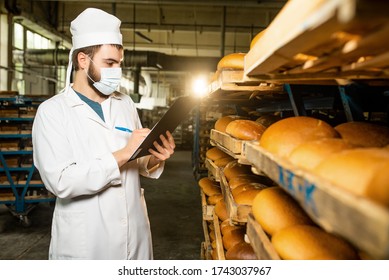 Bread. Bread production line. A man in uniform. Sanitary check. bakery - Shutterstock ID 1743037967