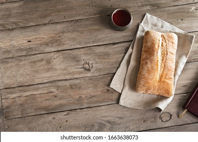 Bread And Red Wine On Wooden Table, Copy Space. Christian Communion Concept.