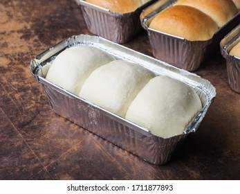 Bread Roll Dough In Aluminium Tin Foil Box On Wooden Table.