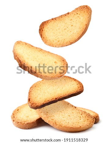 Bread rusks falling on a heap on a white background, levitating crackers. Isolated