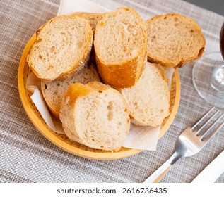 Bread sliced and served on table in wicker plate