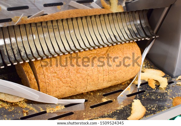 Bread\
slicer in a supermarket. Industrial bread\
slicer.