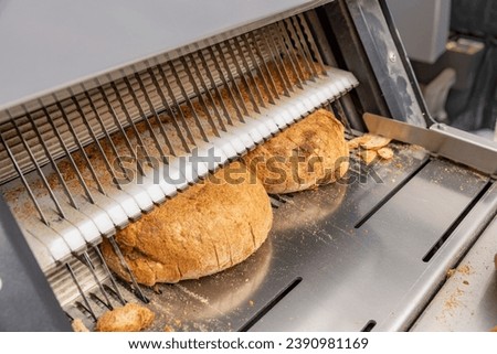 Bread slicing machine. Sliced bread on the production line of food and bakery products.