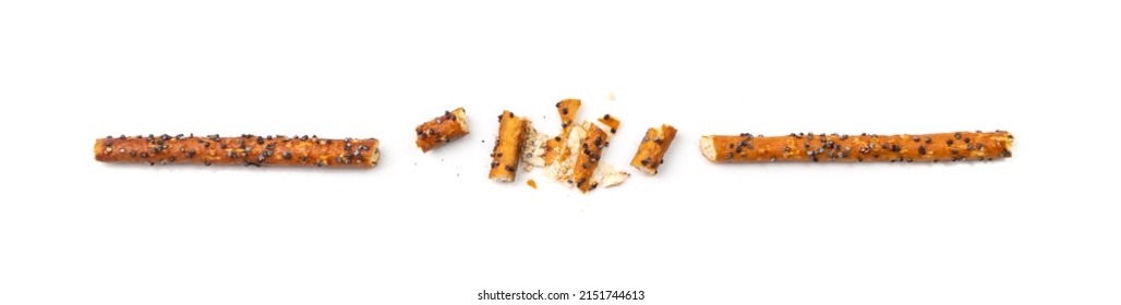 Bread sticks isolated. Crumbled, broken pretzel sticks with poppy seeds, straws pieces, sesame grissini, pretzels snack, breadstick crumbs, long rusks on white background