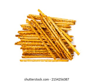 Bread sticks isolated. Pretzel sticks pile, straws, sesame grissini, pretzels snack, breadstick with sesame seeds, long rusks on white background