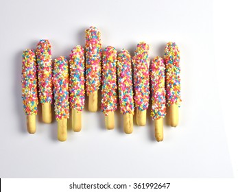 Bread sticks with strawberry chocolate and colorful sprinkles for children, Snack for kids