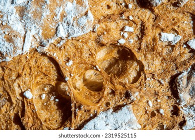 Bread texture close up. Fresh organic homemade sourdough bread loaf with marks from bread proofing basket and flour. Golden artisan bread crust. Top view, macro shot. - Powered by Shutterstock