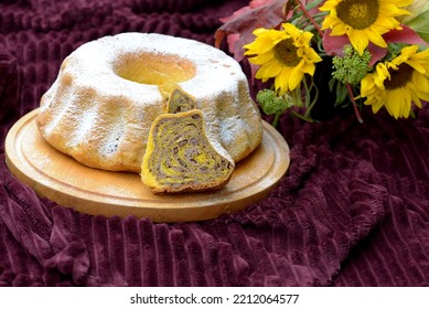 Bread Texture Of Home Baked Potica, Sweet Pumpkin Bread Roll Stuffed With Walnuts. Slice Of Festive Walnut Bread Cake With Remaining Sweet Bread Roll And Autumn Decoration In Background.