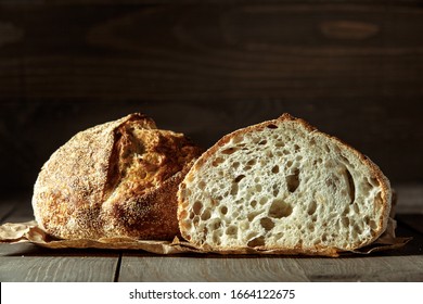 Bread, traditional sourdough bread cut into slices on a rustic wooden background. Concept of traditional leavened bread baking methods. Healthy food. - Shutterstock ID 1664122675