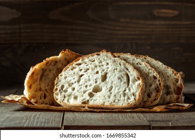 Bread, traditional sourdough bread cut into slices on a rustic wooden background. Concept of traditional leavened bread baking methods. Healthy food. - Shutterstock ID 1669855342
