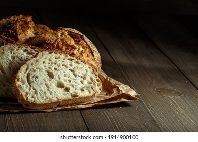 Bread, traditional sourdough bread cut into slices on a rustic wooden background. Concept of traditional leavened bread baking methods. Healthy food. - Shutterstock ID 1914900100