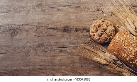 Bread And Wheat On Wooden Background