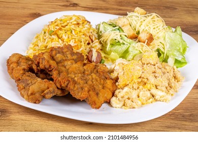 Breaded Beef Steak Served With Caesar Salad, Biro Biro Rice And Egg Farofa. Brazilian Food Usually Served As An Executive Dish