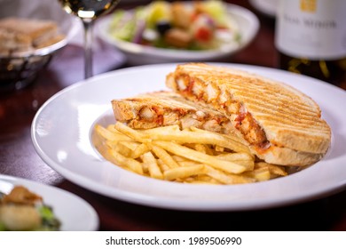 Breaded Chicken Breast Parmigiana Provolone And Mozzarella Cheese Toasted Sliced Artisan Sourdough Bread Panini On White Plate With French Fries And Salad