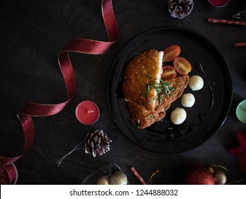 Breaded Chicken Cutlet With Mashed Potatoes. Christmas Dinner On Black Table. Dark Food Photography For Christmas. Christmas Fine Dining At Home.