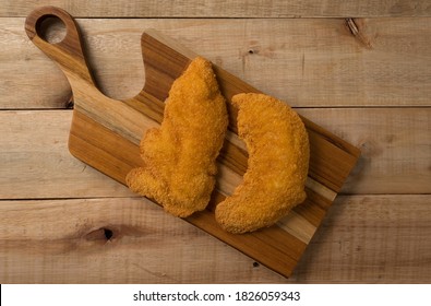 Breaded Chicken Filet
, On A Wooden Background. Top Wiew