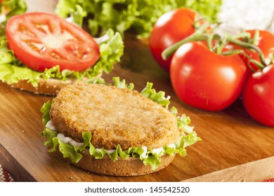 Breaded Chicken Patty Sandwich On A Bun With Lettuce And Tomato