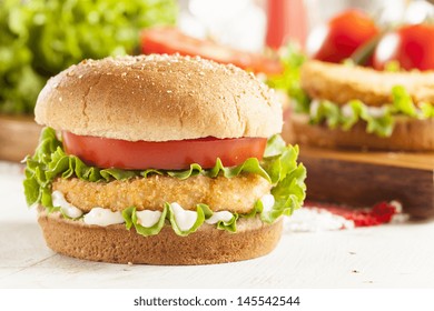 Breaded Chicken Patty Sandwich On A Bun With Lettuce And Tomato