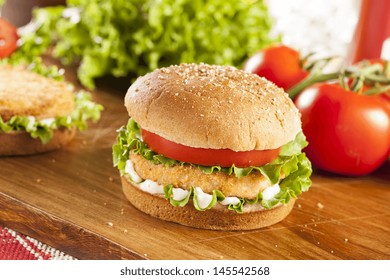 Breaded Chicken Patty Sandwich On A Bun With Lettuce And Tomato