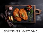 Breaded Chicken pork schnitzel steak chop closeup isolated on wooden background. display, whole and side view. frontal full view. lifestyle studio shoot. closeup view. Top view Flat lay	
