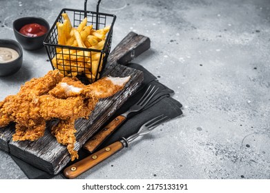 Breaded chicken strips with french fries and ketchup. Gray backgrund. Top view. Copy space. - Shutterstock ID 2175133191