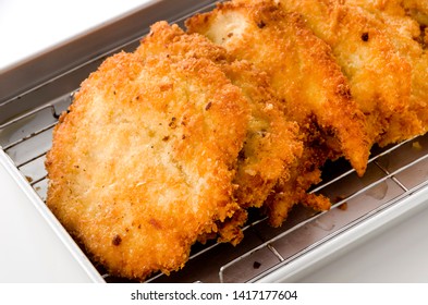 Breaded Chicken Strips On Aluminum Tray On White Background.Chicken Tender Cutlet. 