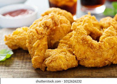 Breaded chicken tenders with ketchup, salad and soda - Shutterstock ID 1012626232