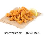 Breaded deep fried strips of clams on an unbleached napkin