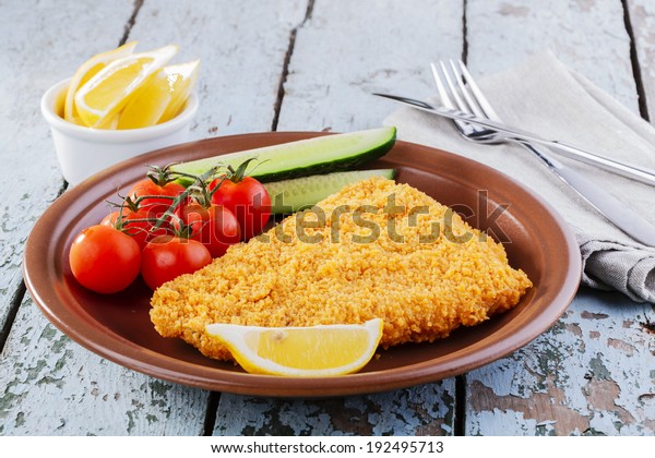 Breaded fish fillet with\
vegetables