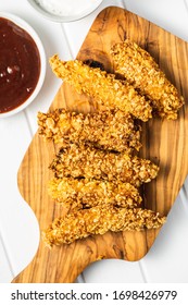 Breaded Fried Chicken Strips And Bbq Sauce On Cutting Board. Top View.Tasty Fast Food.