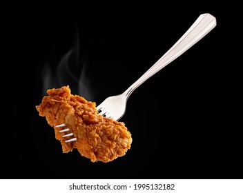 Breaded Fried chicken wings drum and flat on a fork with smoke. copy space area.