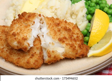 Breaded Haddock Fillets With Mash And Peas.