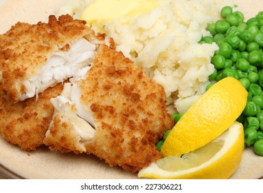 Breaded Haddock Fish Fillets Served With Peas And Mash