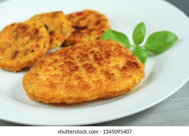 Breaded schnitzel and vegetable pucks