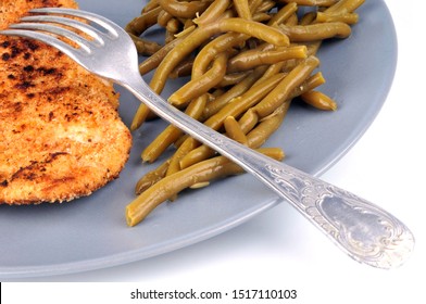 Breaded Veal Cutlet With Green Beans In A Plate Close Up