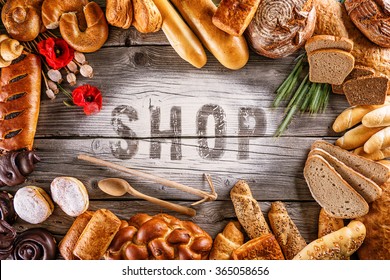 Breads, Pastries, Christmas Cake On Wooden Background With Letters, Picture For Bakery Or Shop