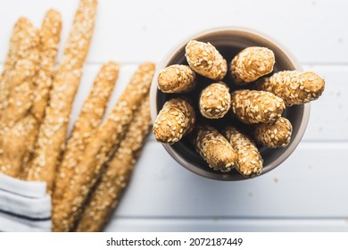 Breadsticks grissini. Bread sticks with sesame seeds in cup. Top view. - Powered by Shutterstock