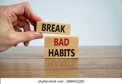 Break bad habits symbol. Wooden blocks with words 'break bad habits'. Male hand. Beautiful wooden table, white background, copy space. Business, psychological and break bad habits concept. - Shutterstock ID 1886952283