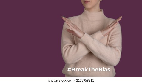 Break the bias symbol of woman's international day. Crossed hands. Woman arms crossed to show solidarity, breaking stereotypes, inequality  - Shutterstock ID 2123959211