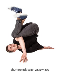 Break Dancer Doing An One Handed Handstand Against A White Background