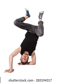 Break dancer doing an one handed handstand against a white background