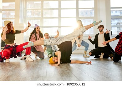 break dancer woman showing different tricks and movements while dancing in the studio, flexible and sportive female on the floor