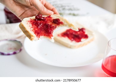 Break To Eat. Pleasant And Tasty Moment Of Relaxation And Tasting. Table With A Glass Of Strawberry Gelatin And Toast With Red Fruit Jam. 