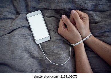 Break Free Of The Technology Chains. Cropped Shot Of A Unrecognizable Persons Hands Bound By A Cellphone Charging Cable.