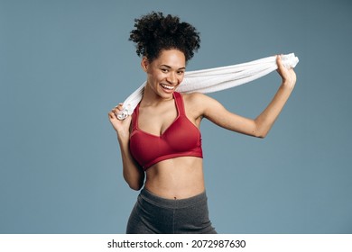 Break At Last. Waist Up Portrait Of Sweaty And Tired Athletic Woman Having Rest After Intensive Working Out. She Is Relaxing With Towel At Her Neck