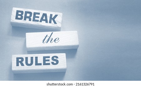 Break The Rules Phrase On Wooden Blocks On Dark Grey. Behavior Concept Or Innovative Business Management Concept