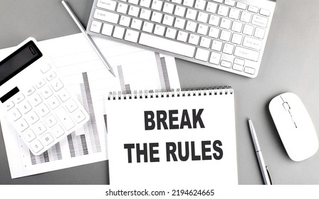 BREAK THE RULES Text Written On A Notebook On Grey Background With Chart And Keyboard, Business Concept